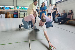 The team competes to place a pen as far away from a line as possible.
