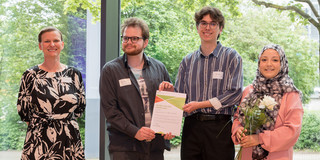 Presentation of the certificate to the team. From left to right: Prof. Tessa Flatten, Finn Tayfun Wieschermann, Maxim Motragh, Sude Peksen.